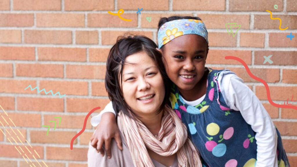 female mentor and student outside by brick wall