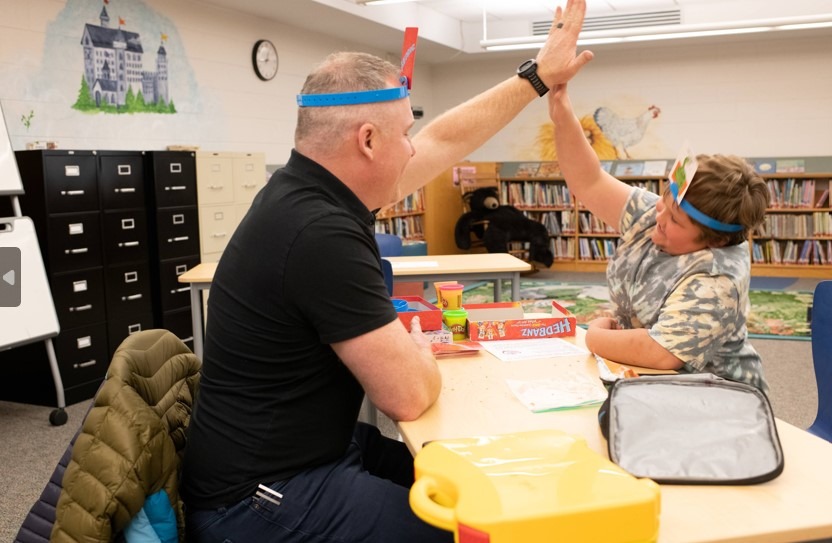 student and mentor giving each other a high five